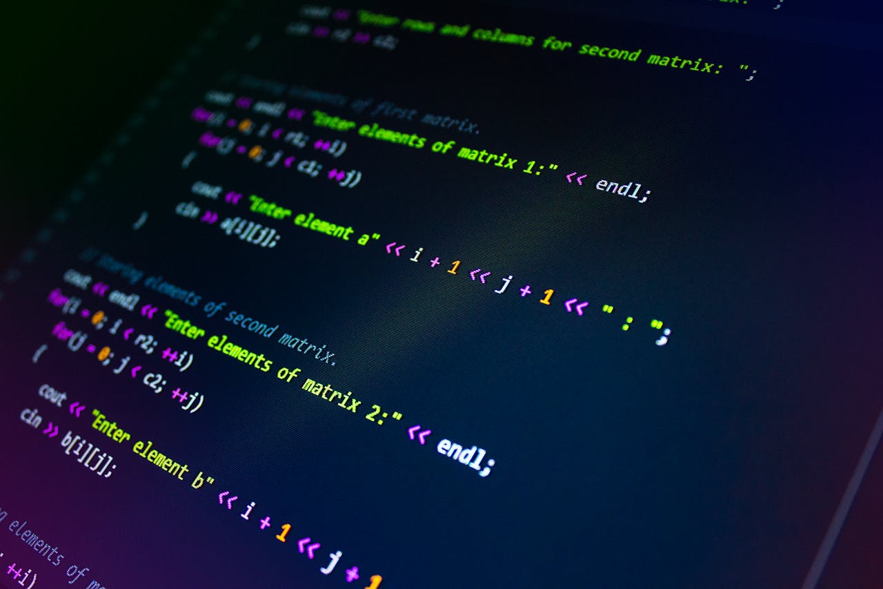 Services Close-up of colorful programming code displayed on a monitor screen.